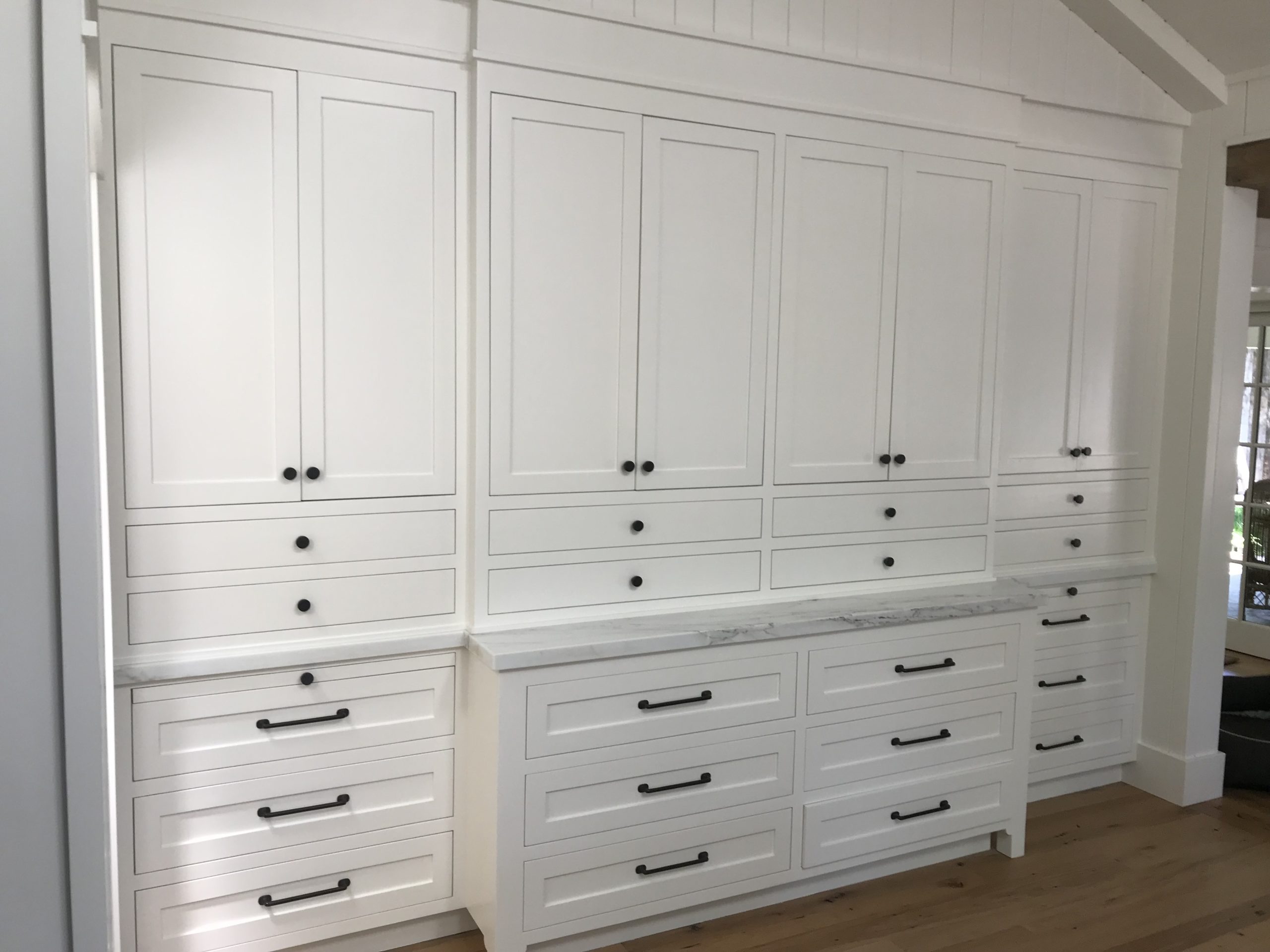 Image of large white cabinets with multiple drawers and black handles, showcasing the craftsmanship of GruberPainting in San Jose.